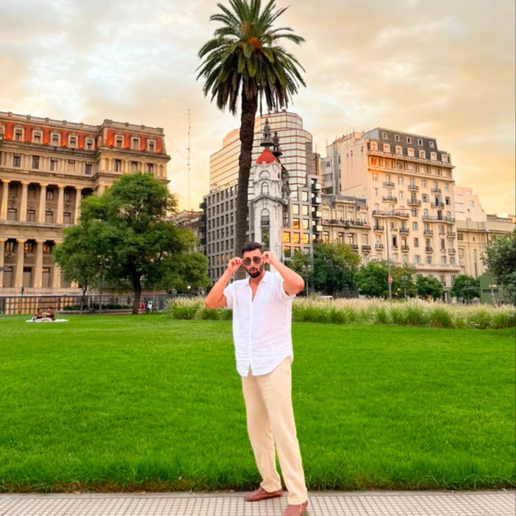 Passport Papi in front of the Colosseum in Rome, illustrating a comparison with Europe
